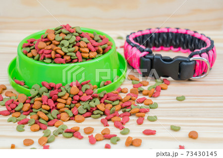 Pet food with dog collar on wooden background 73430145