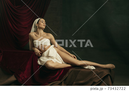 Modern remake of classical artwork with coronavirus theme - young medieval woman on dark background 73432722