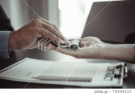 Businessmen give dollars to bribe employees in signing contracts to buy illegal land and real estate, Business fraud and social injustice, corruption and bribery concept. Businessmen give dollars to bribe employees in signing contracts to buy illegal land and real estate, Business fraud and social injustice, corruption and bribery concept. 73434112