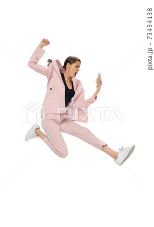 Happy young woman dancing in stylish clothes or suit, remaking legendary moves of celebrity from culture history Happy young woman dancing in stylish clothes or suit, remaking legendary moves of celebrity from culture history 73434138