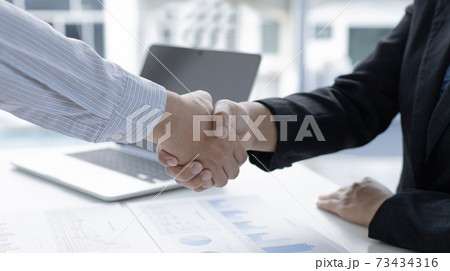 Financial accountants and marketers shaking hand to congratulate the double-digit real estate performance, Meetings and hand shake concept. 73434316
