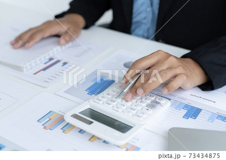 Accounting businesswomen are calculating income-expenditure and analyzing real estate investment data, Dedicated to the progress and growth of the company, Financial and tax systems concept. 73434875