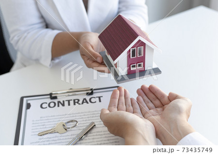 Real estate broker has given the house to customers who bought the house with insurance, Negotiating purchase-sale and investment planning concept. Real estate broker has given the house to customers who bought the house with insurance, Negotiating purchase-sale and investment planning concept. 73435749
