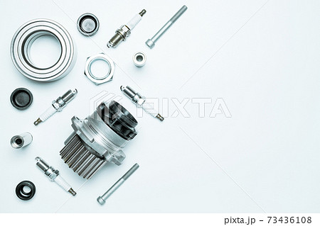 Car service. Auto motor mechanic spare or automotive piece on white background. Set of new metal car part. Repair and vehicle service with space for text. 73436108