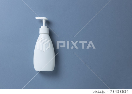 White bottle with hand soap, shower gel or body cream on gray background, mock up with place for text or copy space. Personal hygiene, skin care concept. Horizontal. Minimal style. Flat lay, top view White bottle with hand soap, shower gel or body cream on gray background, mock up with place for text or copy space. Personal hygiene, skin care concept. Horizontal. Minimal style. Flat lay, top view 73438634