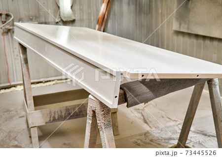 Painting cabinets with spray gun . Painting chamber, spray gun. Furniture manufacture 73445526