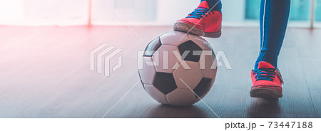 Soccer Kid feet stepping on a football for youth indoor sport. Soccer Kid feet stepping on a football for youth indoor sport. 73447188
