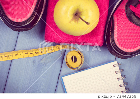Sport shoes, accessories for fitness and fresh apple. Healthy sporty lifestyles Sport shoes, accessories for fitness and fresh apple. Healthy sporty lifestyles 73447259