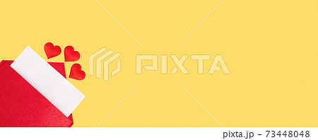 Banner red open envelope with a sheet of paper with a hearts on a yellow background with mock-up. Valentines day holidays concept and love notes, christmas and new year letters for Santa Claus 73448048