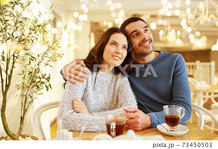 happy couple drinking tea at restaurant happy couple drinking tea at restaurant 73450503
