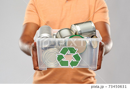 close up of young man sorting metallic waste close up of young man sorting metallic waste 73450631