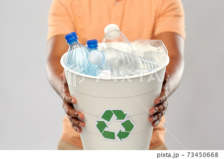 close up of young man sorting plastic waste 73450668