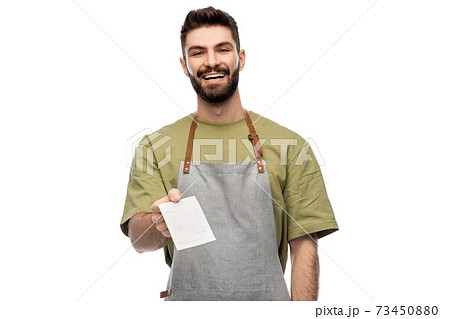 happy smiling barman in apron with bill 73450880