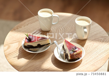 pieces of chocolate cake on wooden table 73450881