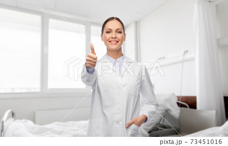 happy female doctor showing thumbs up at hospital happy female doctor showing thumbs up at hospital 73451016