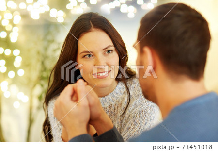 happy couple holding hands at restaurant or cafe happy couple holding hands at restaurant or cafe 73451018
