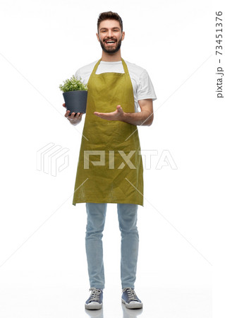 happy smiling male gardener with flower in pot happy smiling male gardener with flower in pot 73451376