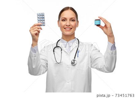 smiling female doctor holding medicine pills smiling female doctor holding medicine pills 73451763