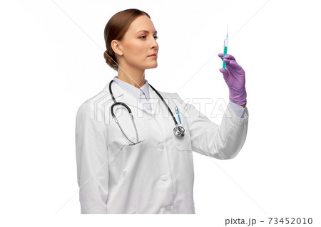female doctor with medicine in syringe female doctor with medicine in syringe 73452010