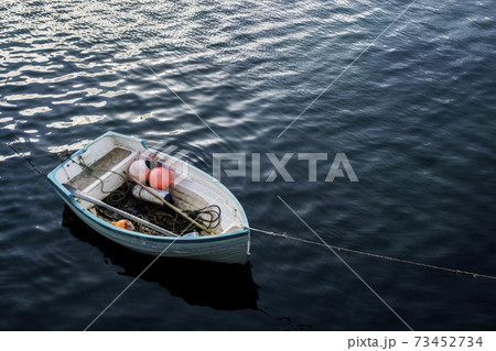 High angle view of small moored fishing boat. 73452734