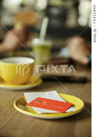 Credit card and bill on cafe table 73452845