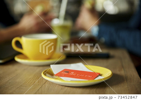 Credit card and bill on cafe table 73452847