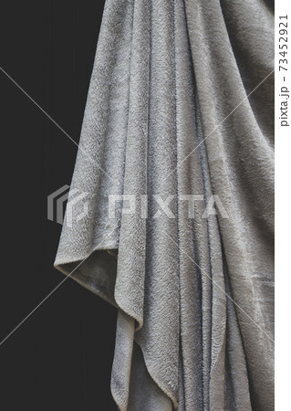 Close up of draped grey velvet fabric, focus on folds and creases 73452921