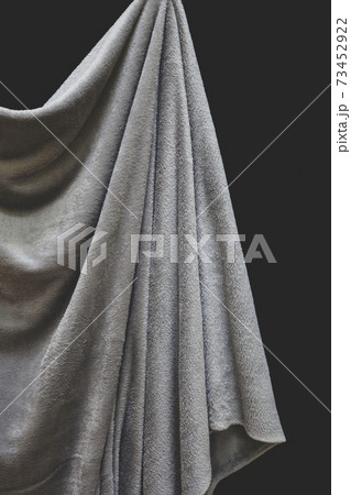 Close up of draped grey velvet fabric, focus on folds and creases 73452922