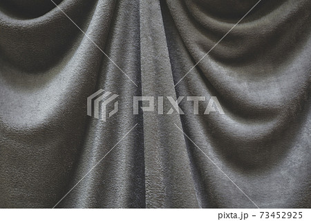 Close up of draped grey velvet fabric, focus on folds and creases 73452925