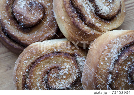 High angle close up of freshly baked cinnamon rolls. 73452934