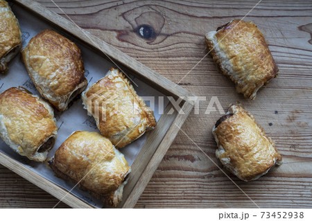 High angle close up of freshly baked sausage rolls. 73452938