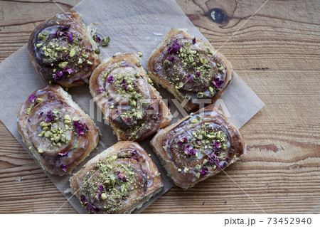 High angle close up of freshly baked Danish Pastries with Pistachio Nuts. 73452940