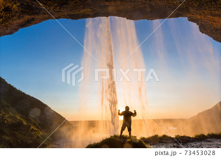 Man behind Seljalandsfoss Waterfall, South Iceland, Iceland 73453028