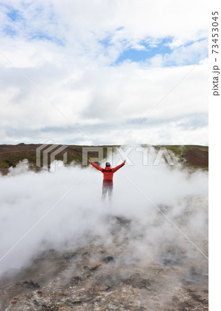Man standing by geothermal pools, South West Iceland Man standing by geothermal pools, South West Iceland 73453045