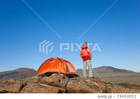 Woman standing by tent, Iceland 73453051
