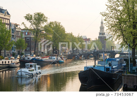 The Oudeschans canal in Amsterdam with the Montelbaanstoren tower in the background, Amsterdam, Holland, Netherlands 73453067