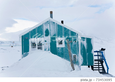 House in winter covered in snow, Tasiilaq, southeastern Greenland 73453095