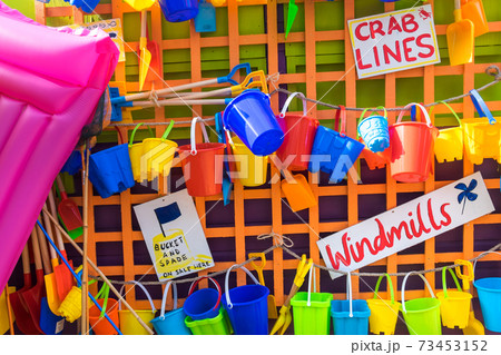 Bucket and spades and other beach items for sale, holiday resort, England, United Kingdom 73453152