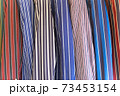 A selection of striped blazers on a rack, traditional leisure wear. 73453154