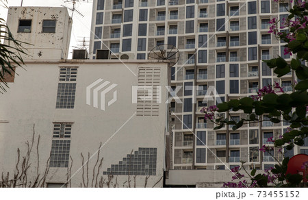 Architectural View of Overlapping old house buildings and modern condominium in bangkok, Thailand. 73455152