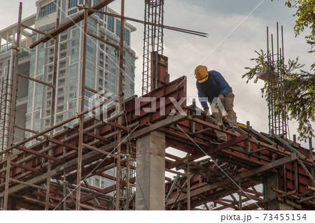Construction Worker Welding soldering metal girders and Sparks. 73455154