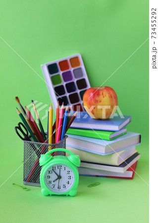 School stationery, books, alarm clock on desk, home learning concept, back to school School stationery, books, alarm clock on desk, home learning concept, back to school 73455292