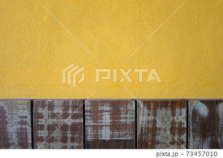 Yellow cement walls and pastel wood planks texture background                                73457010