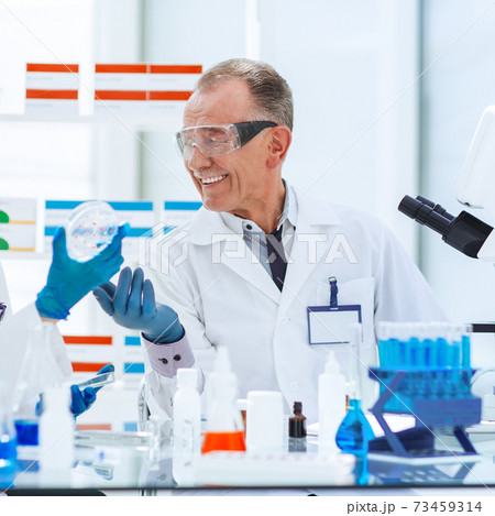 close up. scientists are conducting research on a new vaccine . close up. scientists are conducting research on a new vaccine . 73459314
