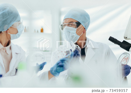close up. scientists discussing the results of their research. close up. scientists discussing the results of their research. 73459357