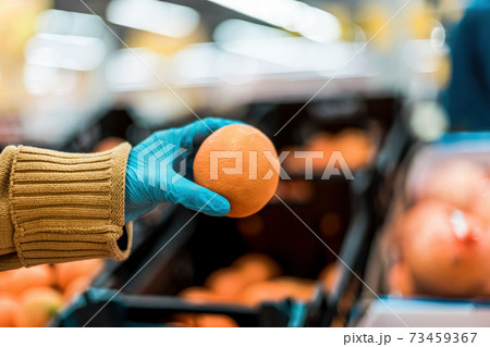 fresh orange in the hands of the buyer .security concept 73459367