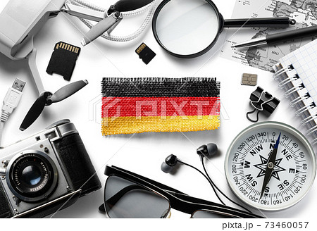 Flag of Germany and travel accessories on a white background. 73460057