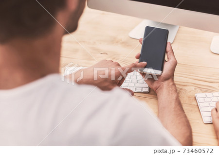 businessman uses his smartphone in the office 73460572