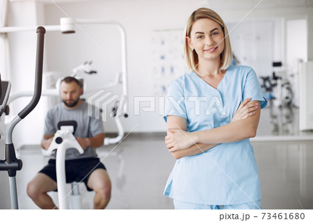 Doctor with a patient in physiotherapy clinic 73461680