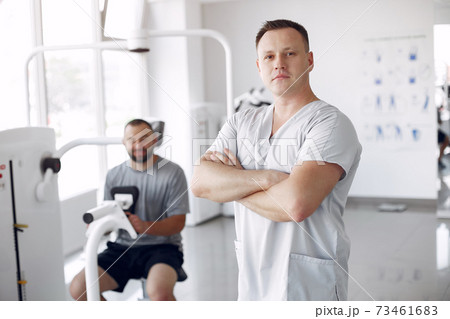 Doctor with a patient in physiotherapy clinic 73461683